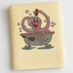 Yellow towel with happy pink octopus in a bathtub spraying bubbles
