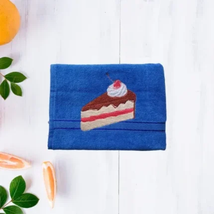 Blue cotton towel with embroidered slice of cake design