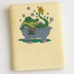 Cream cotton towel with cartoon crocodile taking a bubble bath embroidered design