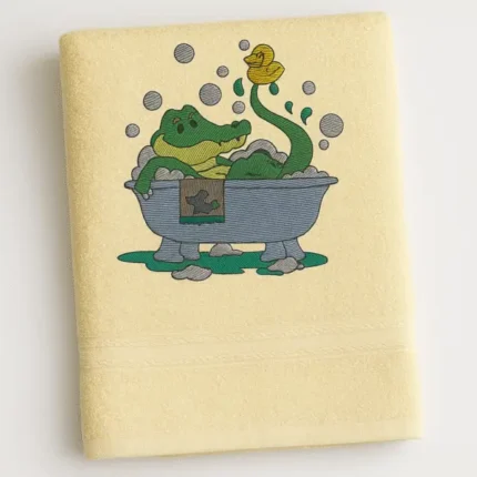 Cream cotton towel with cartoon crocodile taking a bubble bath embroidered design