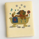 Cream cotton towel with cartoon dog taking a bubbly bath embroidered design