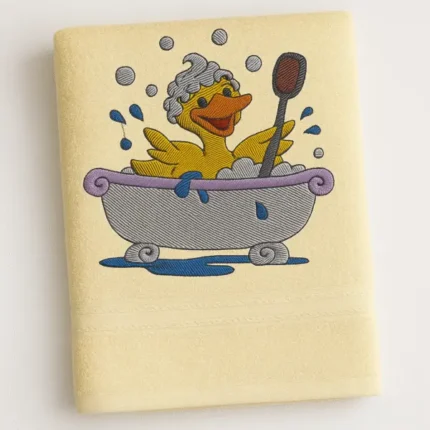 Cream cotton towel with cartoon duck taking a bubbly bath embroidered design