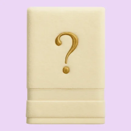 Cream towel with golden embroidered question mark on pastel background