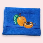 Blue cotton towel with embroidered apricot fruit and leaf design