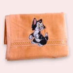 Peach towel with black and white cartoon cat embroidery and decorative border