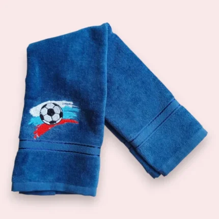 Blue towel with football embroidery and red, white and blue brush stroke accents