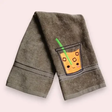Brown towel with cute smiling juice glass embroidery and green straw