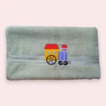 Light green kids towel with colourful embroidered toy train engine design