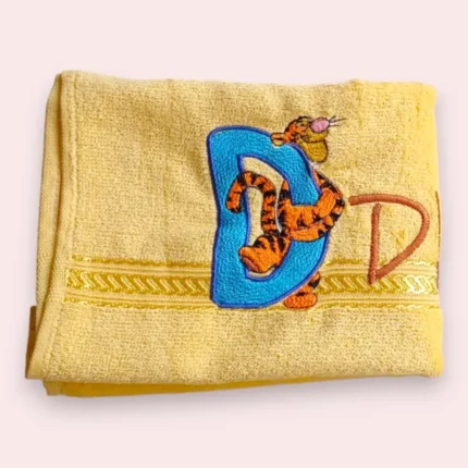 Yellow kids towel with embroidered Winnie style D monogram and tiger character